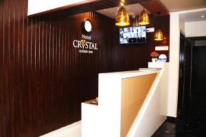 a bar in a restaurant with a clock on the wall at Hotel Crystal Luxury Inn- Bandra in Mumbai