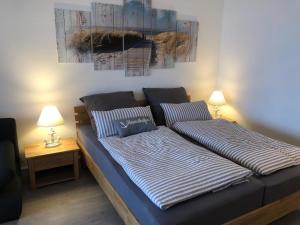a bed with two pillows on it in a room at Appartement Ankerplatz in Glücksburg