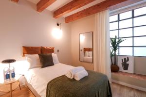una camera con un letto e una grande finestra di Sweet Inn - Verdi a Barcellona