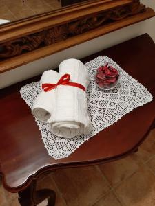 a towel with a red ribbon sitting on a table at Villa Iole in Assemini