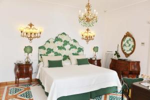 
a bedroom with a large bed and a large lamp at Buca Di Bacco in Positano
