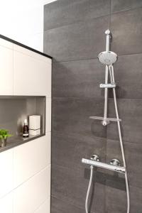 a shower in a bathroom with a glass door at Gorgeous And Stylish Place For Two In Hip West! in Amsterdam