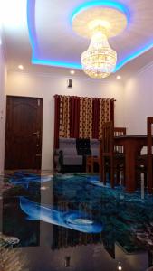 a living room with a glass floor and a chandelier at Wayanad Snow Vibes in Vythiri