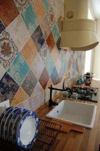 a kitchen with a sink and a stove and a counter top at Casa Pica in Naples
