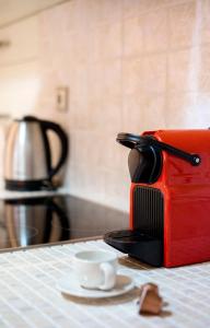 a red toaster sitting on top of a counter at Valashouse in Athens