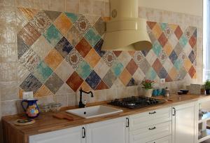 a kitchen with a sink and a tiled wall at Casa Pica in Naples +50 photos
