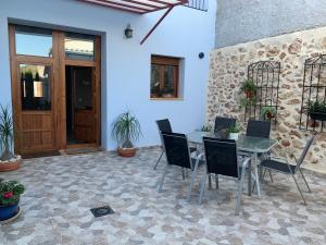 a patio with a table and chairs and a door at Ca La Martí in Pedreguer