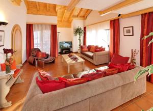 a large living room with a large couch at Beny Duplex in Grächen