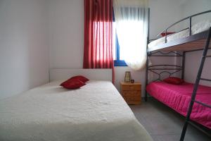 a bedroom with two bunk beds and a window at Dolphins House in Paralía Avdhíron