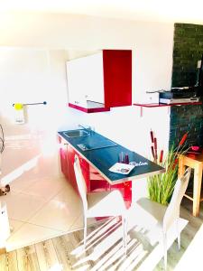 a kitchen with a counter with a sink and two chairs at Central Studio with Lake View | 102 in Montreux