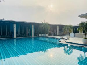 a large blue swimming pool in a building at The Landmark Towers in Kānpur