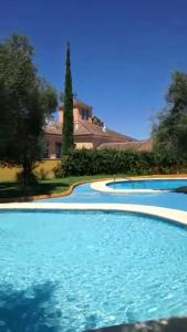 a large swimming pool in front of a house at Casa Sevilla in Valencina de la Concepción