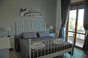 a bedroom with a bed and a balcony at Le Anfore in Marino