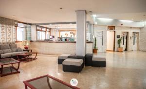 a living room with a couch and a table at Apartamentos Palm Beach Club Carihuela in Torremolinos