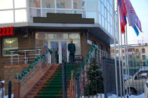 a man standing in the doorway of a building at "Rush Hotel" in Astana