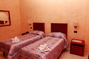 Posteľ alebo postele v izbe v ubytovaní Hotel Ulisse