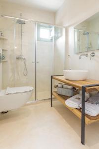 a bathroom with a tub and a sink and a shower at Sea and Sun Luxury Pools' Villas in Chorefto +52 photos