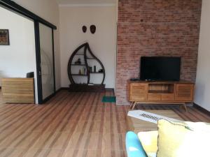 a living room with a couch and a television at Jogja City Residence in Yogyakarta