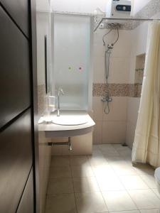 a bathroom with a sink and a shower at Jogja City Residence in Yogyakarta