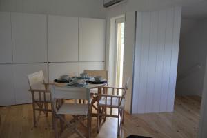 a dining room with a table and chairs at Moinhos da Corga in Antigo