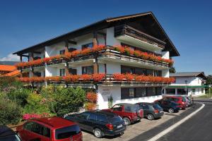 a large building with cars parked in front of it at Gästehaus Baumgartner in Oberstdorf