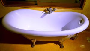 a white sink with a faucet in a bathroom at PrideInn Mara Camp & Cottages in Talek
