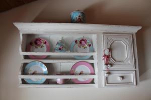 a white cabinet with plates and vases on it at Ferienwohnung Landhausliebe in Zwiesel