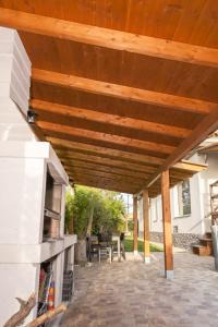 a patio with a wooden pergola at Chalet de lujo in Murcia