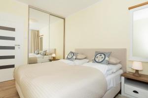 Posteľ alebo postele v izbe v ubytovaní Jantar Apartamenty Exclusive Polanki Park SPA