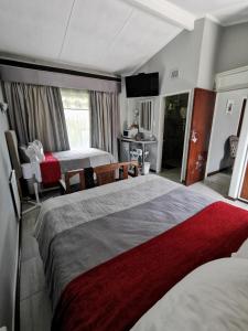 a hotel room with two beds and a television at Stew s Room in Polokwane