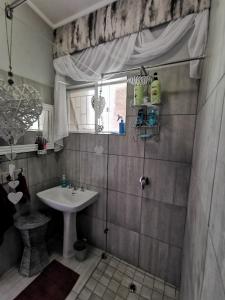 a bathroom with a sink and a shower at Stew s Room in Polokwane +69 photos