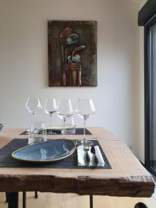 - une table avec une assiette et des verres à vin dans l'établissement Le Cottage de Vany, à Vany