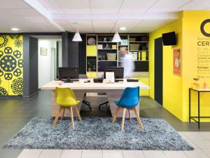 a kitchen with a table and chairs and a table top at Aparthotel Adagio Access Strasbourg Petite France in Strasbourg