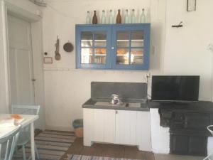 a kitchen with a sink and a blue cabinet at Brunnsta Gård in Bålsta