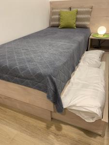 a bedroom with a bed with a gray comforter at Ferienwohnung am Regierungsplatz in Landshut