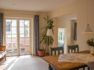 a dining room with a table and a view of a balcony at Schlösschen im Weinberg in Meersburg