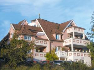 a large white building with a brown roof at Schlösschen im Weinberg in Meersburg