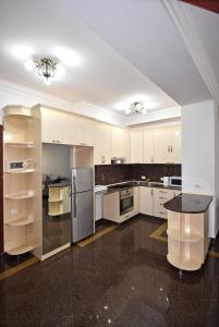 a large kitchen with white cabinets and appliances at Buzand street 1 bedroom Newly Renovated apartment near Republic Square BU777 in Yerevan