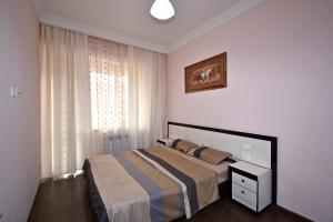 a bedroom with a bed and a window at Buzand street 1 bedroom Newly Renovated apartment near Republic Square BU777 in Yerevan