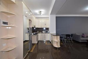 a kitchen and living room with white cabinets and a table at Buzand street 1 bedroom Newly Renovated apartment near Republic Square BU777 in Yerevan +19 photos