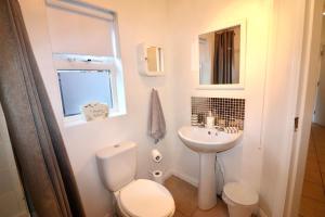 a white bathroom with a toilet and a sink at Clifton Park in Belfast +10 photos