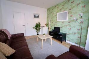 a living room with a couch and a table at Clifton Park in Belfast