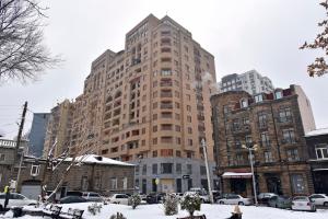 a tall building in a city with snow on the ground at Buzand street 1 bedroom Newly Renovated apartment near Republic Square BU777 in Yerevan