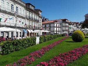 a garden with flowers in front of a building at VIANA é AMOR apartamento no centro histórico in Viana do Castelo