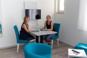 two women sitting at a table in a room at Kloster Maria Hilf in Bühl