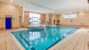 a large swimming pool in a large room at The Aberdeen Altens Hotel in Aberdeen