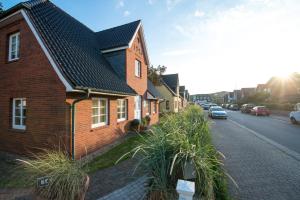 a brick house on the side of a street at Sylt Island House in Westerland