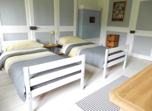 two twin beds in a room with at Chambres d'hôtes T'22 in Fleurier