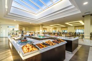 a buffet in a hotel with food on display at Royal Palm Resort & Spa - Adults Only in Playa Jandia