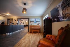 a living room with a couch and a piano at Kirkjufell Hotel by Snæfellsnes Peninsula West Iceland - Grundarfjordur in Grundarfjordur